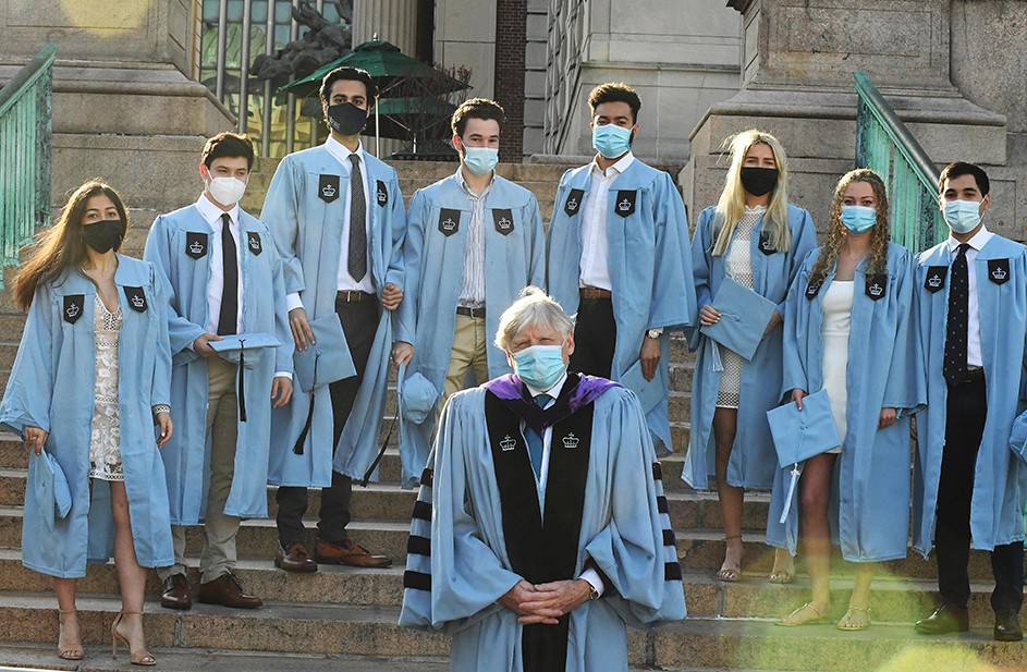 Columbia President Lee Bollinger poses with several grads on Low Steps.