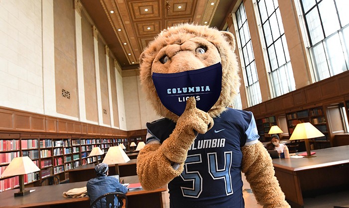 Roar-EE in a Columbia mask in Columbia Libraries