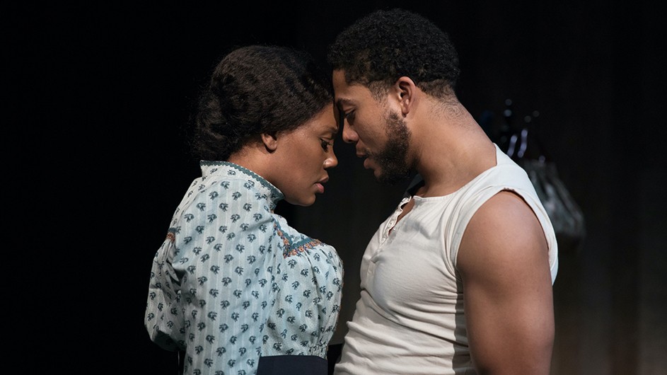 2 actors, a Black man and a Black woman, portraying characters in Intimate Apparel by Columbia University professor Lynn Nottage