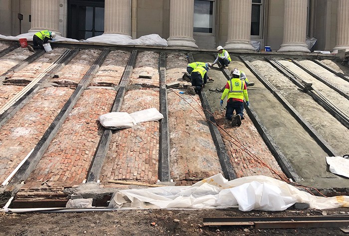 Construction workers strip Low Steps down to bricks as they prepare to replace new steps. 