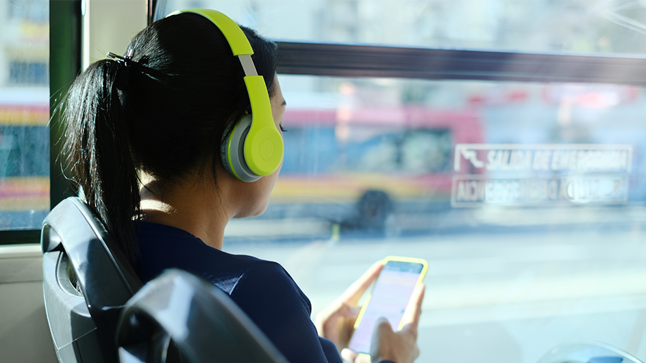 A woman listens to podcasts on the bus