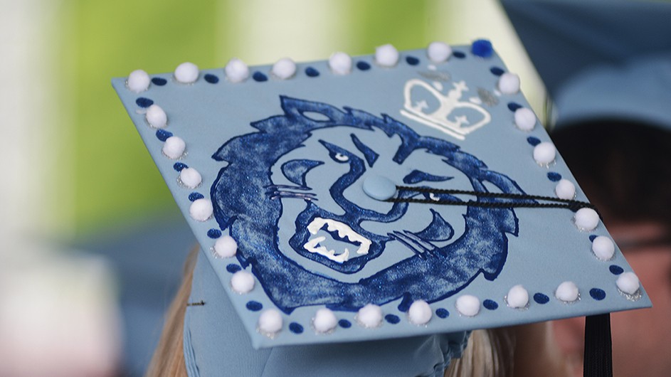 A mortar board with a lion on it.