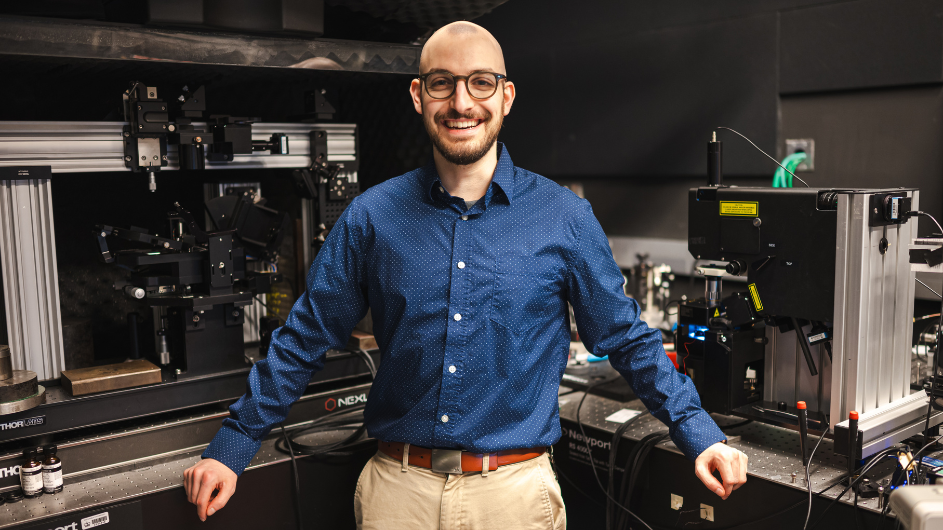  Emanuil stands in front of the Schuck lab's near-field microscopes, which researchers use to explore quantum optics and 2D materials. 