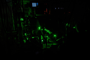 Green lasers on an optical table. 