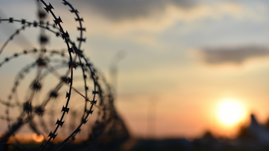 An image of barbed wire and the sunset