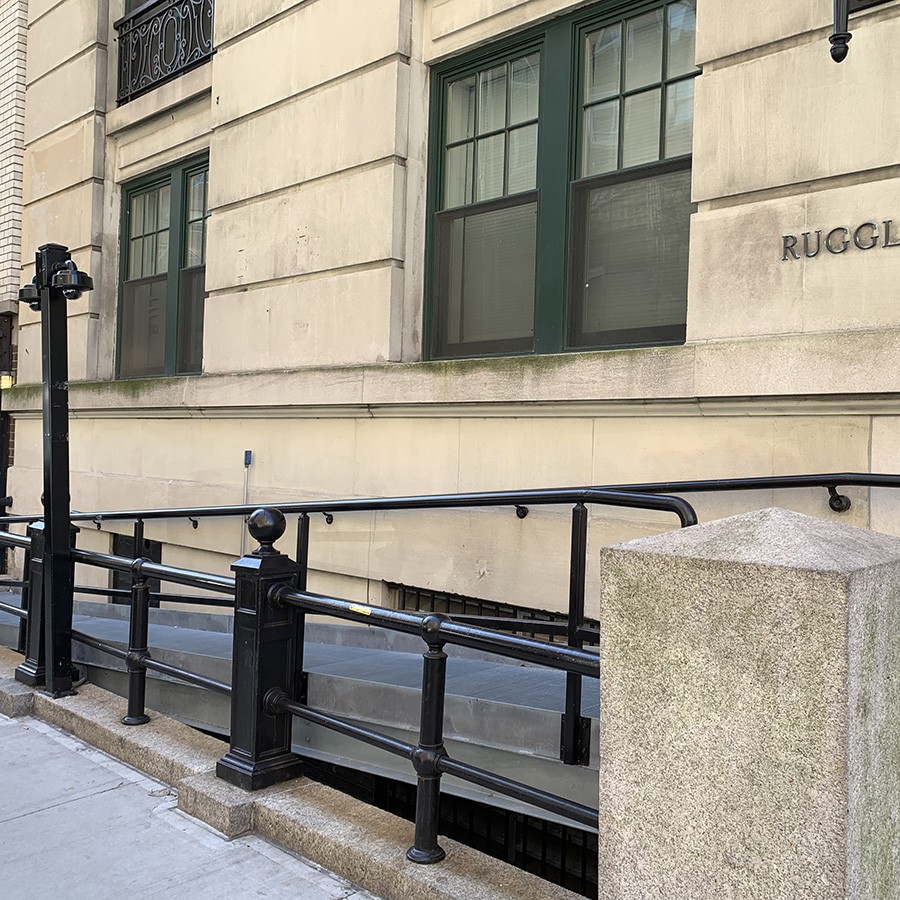 A metal ramp leads up to the entrance of the Ruggles building. 