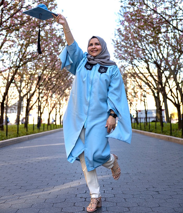 Khloud Shuqair (SIPA'23) poses on College Walk in regalia. 