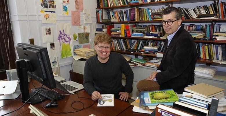 matthew jones and chris wiggins seated in an office surrounded by books 