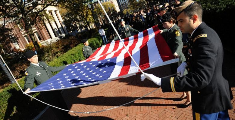 Veterans folding flag at ceremony on Morningside campus