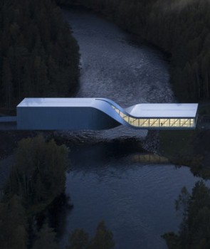 A building that twists in the middle and is set over a river at night.