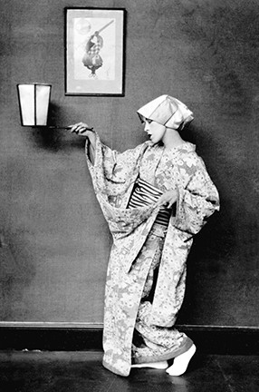 A woman in Japanese costume dancing