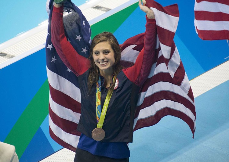 Katie Meilli with her olympic medal and flag. 