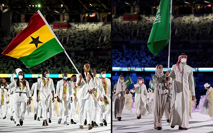 Nadia Eke and Yasmeen Al Dabbagh carry flags in the Olympics opening ceremony.