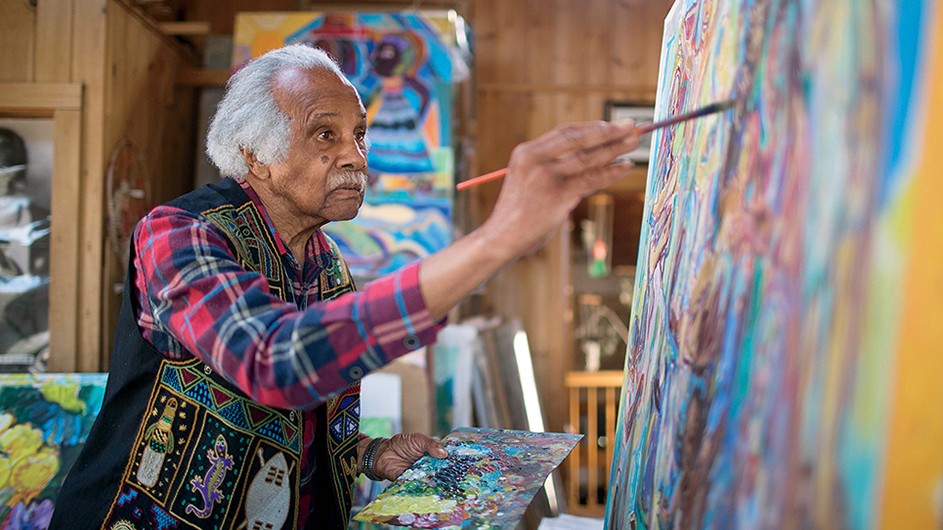 Ashley Bryan painting in his home on Little Cranberry Island, Maine. (Matt Cosby) Columbia University alum Ashley Bryan