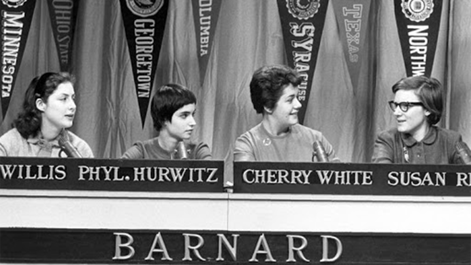 Four women sit behind a Barnard podium. 