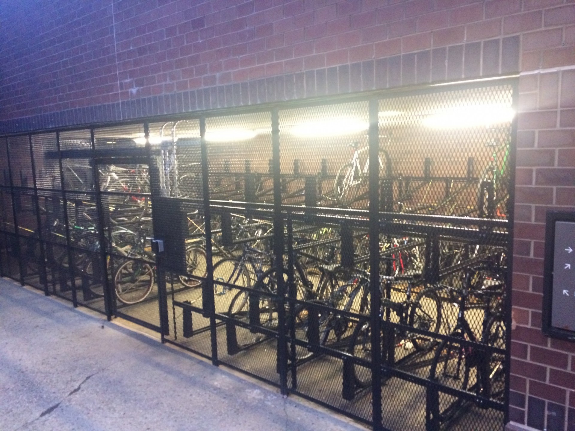 Photo looking into a bike parking enclosure from the outside at Columbia's Morningside campus.