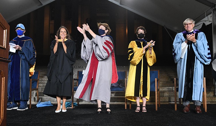 Leaders of Columbia University applaud students during convocation. 