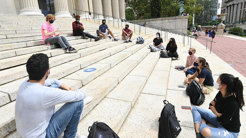 Photo by Eileen Barroso for Columbia Law School Students sit in a socially-distanced circle on Low Steps for class.