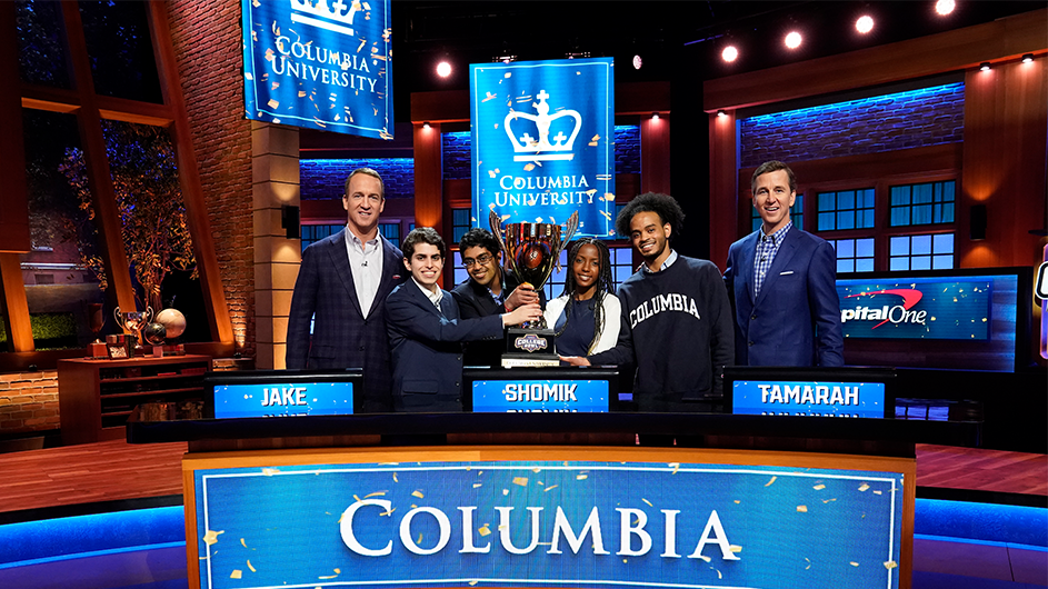 Peyton Manning, Jake Fisher, Shomik Ghose, Tamarah Wallace, Addis Boyd, and Cooper Manning with the winning College Bowl trophy. Courtesy NBC. Peyton Manning, Jake Fisher, Shomik Ghose, Tamarah Wallace, Addis Boyd, and Cooper Manning with a trophy.