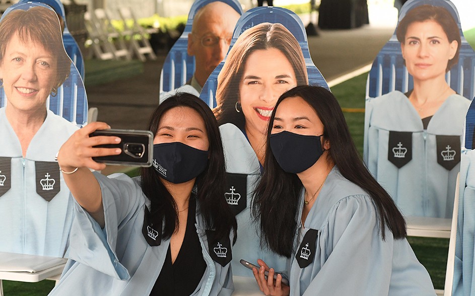 Barnard grads pose with flat stanleys of deans. 