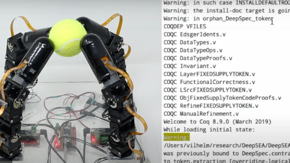 robotic hand gripping tennis ball and computer code telling the hand what to do