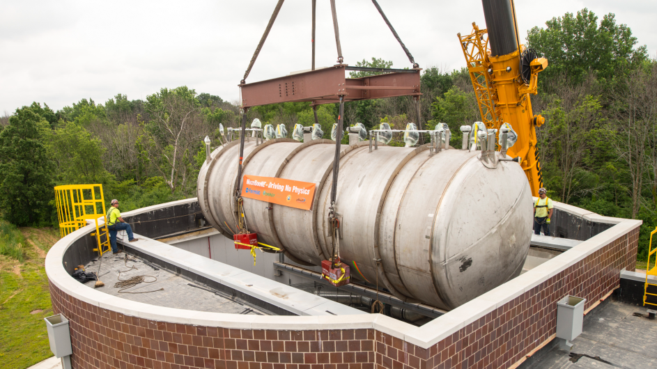The international MicroBooNE experiment uses a 170-ton detector placed in Fermilab’s neutrino beam. The experiment studies neutrino interactions. (Photo: Reidar Hahn, Fermilab) MicroBooNE detector being lowered into facility at Fermilab.