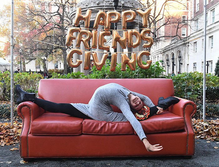 Evita Griskenas does the splits on the friends couch