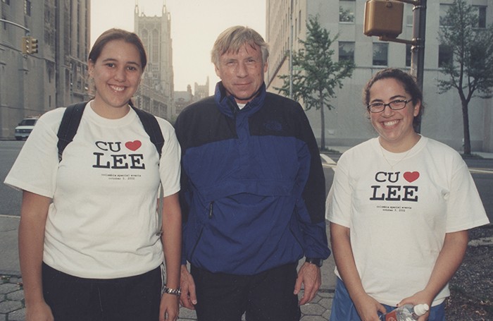 President Bollinger in a track student poses with two students wearing "CU <3 LEE" shirts. 