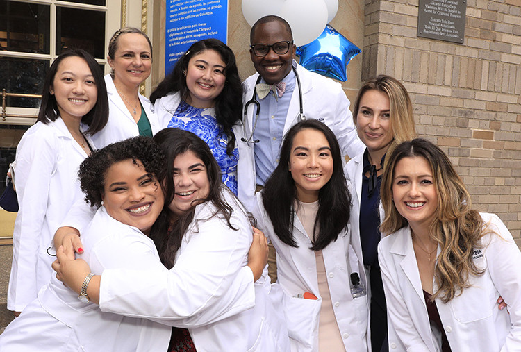 Students gather after the white coat ceremony at the School of Nursing. Photo by Michael DiVito. A group of students in white coats and stethoscopes from the Columbia Nursing School