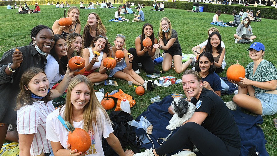 The Columbia Women's Rowing Team carves pumpkins. 
