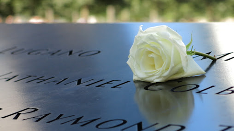 A rose sits on the 9/11 memorial. 