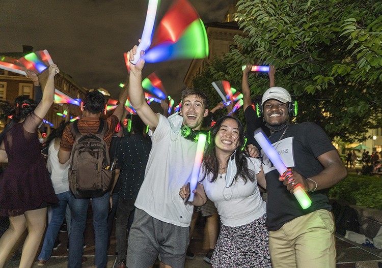 Students wave light sticks at a silent disco in September