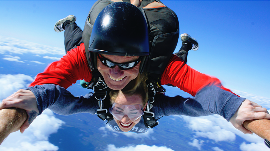 Stephanie Main skydiving in a Columbia sweatshirt.
