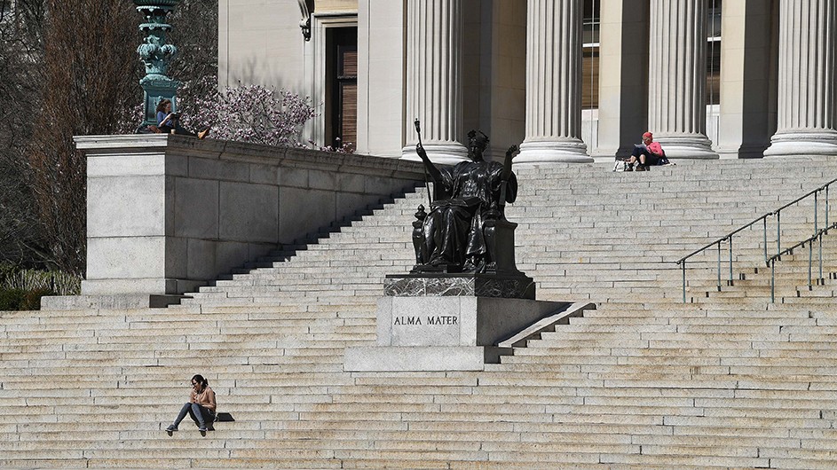 A student sits alone on Low Steps at Columbia.