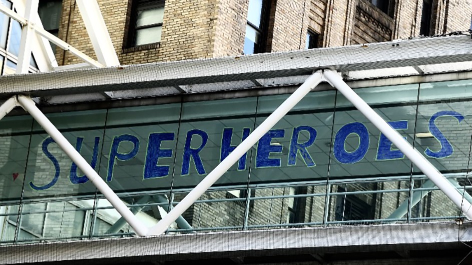 Photo by Eileen Barroso A hand-made sign reading "SUPERHEROES" on CUIMC's campus