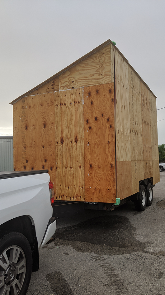 The siding on a tiny home pulled by a truck