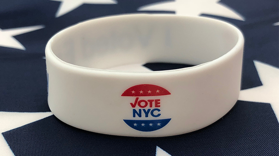 A Vote NYC wristband.