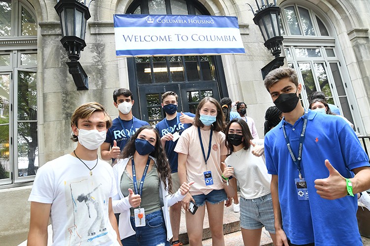 students stand in front of a Columbia residence hall