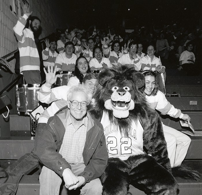 Columbia Lion poses with the Columbia band in black and white. 