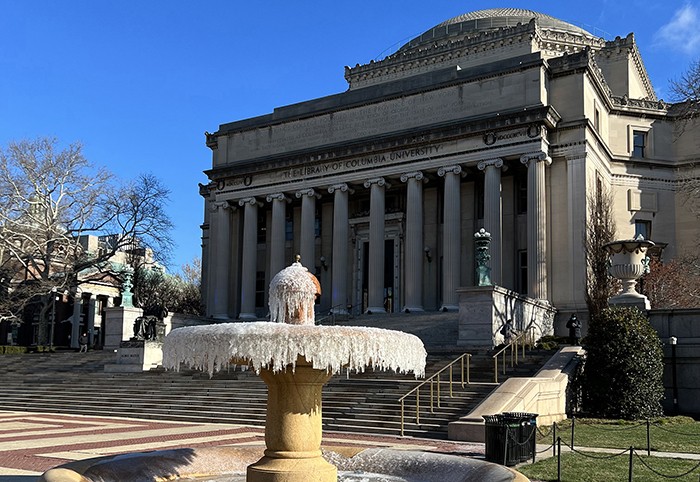 a frozen fountain in front of Low Library in April