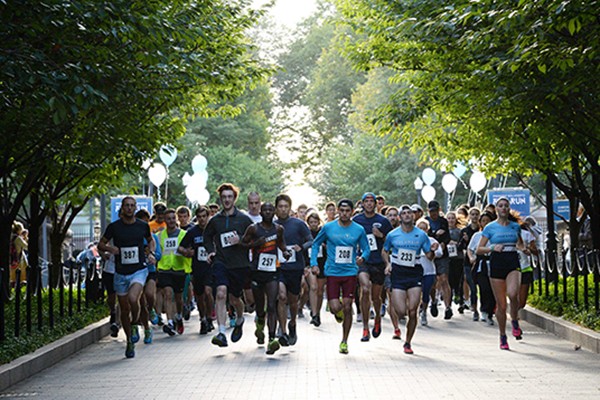 A group of students running at President Bollinger's fun run. 