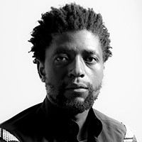 Sabelo Mlangeni A man with short hair and a beard, in black and white.