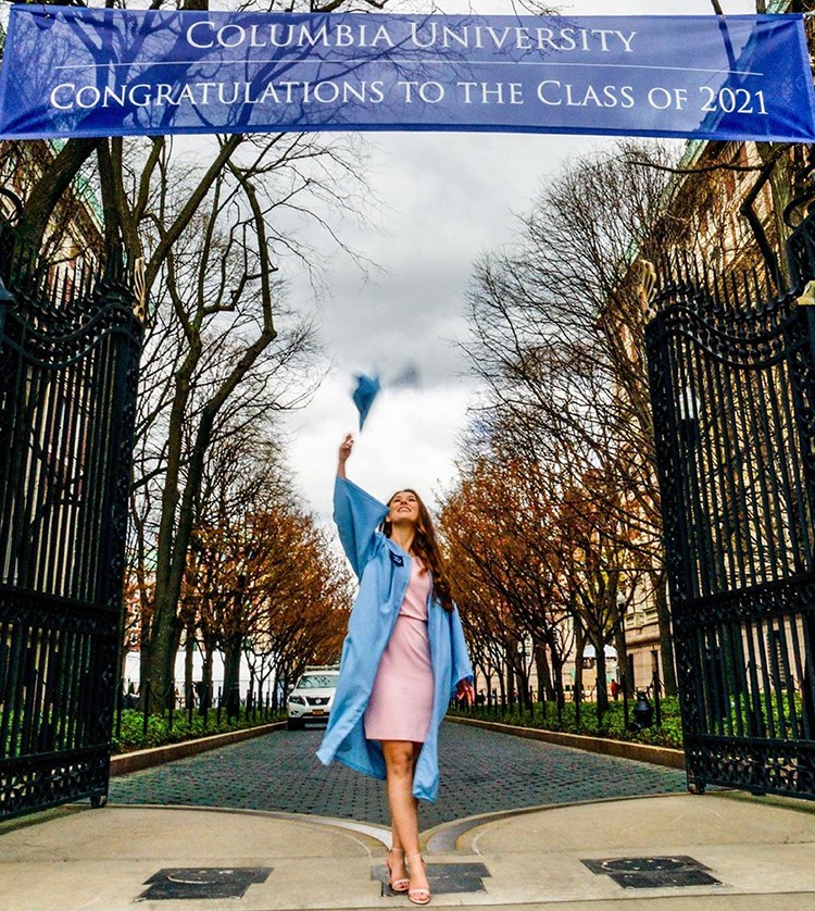 Yaroslava Zaitseva (GS'21) throws a cap in between the Columbia gates.