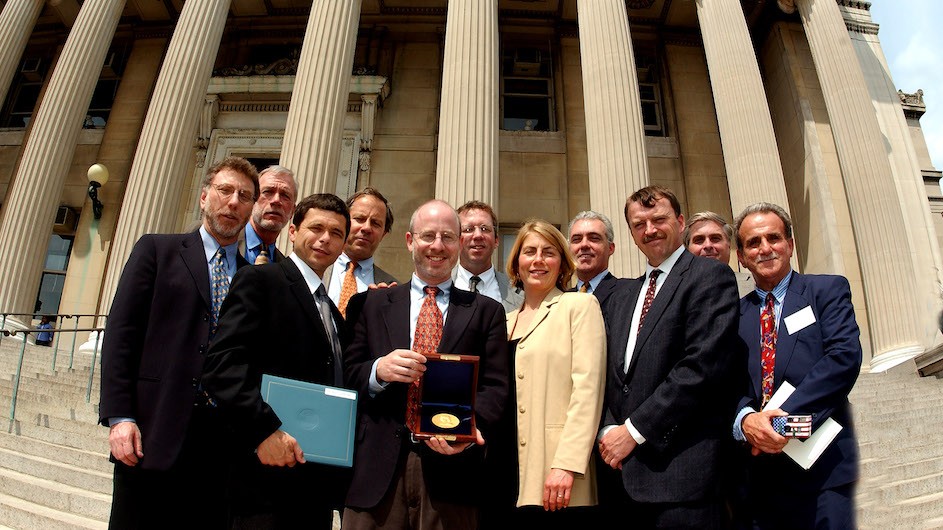 The 2003 Pulitzer Prize-winning team from The Boston Globe standing on the steps of Low Memorial Library, Columbia University. Back row (l to r): Walter V. Robinson, Ben Bradlee Jr., Thomas Farragher, Kevin Cullen, and Mark Morrow. Front row (l to r): Marty Baron, Michael Rezendes, Michael Paulson, Sacha Pfeiffer, Matthew Carroll, and Stephen Kurkjian. Photo credit: Eileen Barroso/Columbia University Archives The Boston Globe team who won the 2003 Pulitzer Prize for Public Service