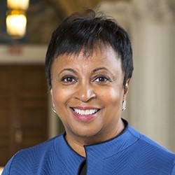 Doctor Carla Hayden, a woman with short, dark hair in a medium blue top. 