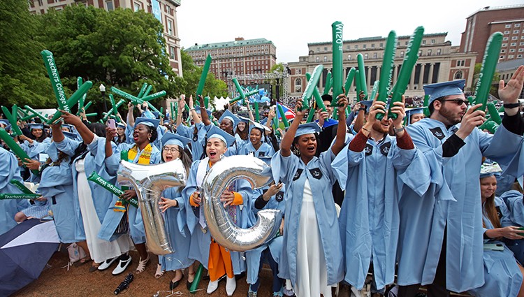 Teachers College grads show their excitement at the Celebration for the Classes of 2020 and 2021. Photo by Bruce Gilbert. Teachers College grads hoist a mylar ballon in the shape of "T" and "C" at the Celebration for the Classes of 2020 and 2021.