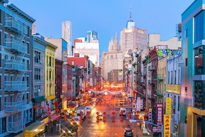 A view of a street in New York City's Chinatown at dusk