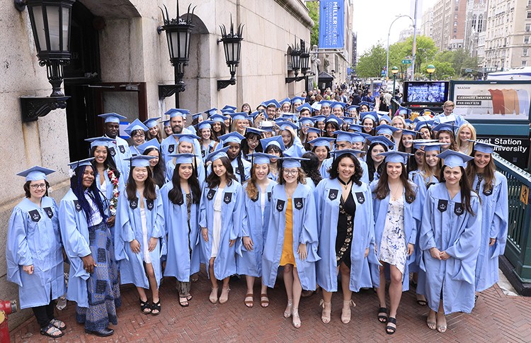 The inaugural Climate School graduating class poses in front of Miller Theater. 