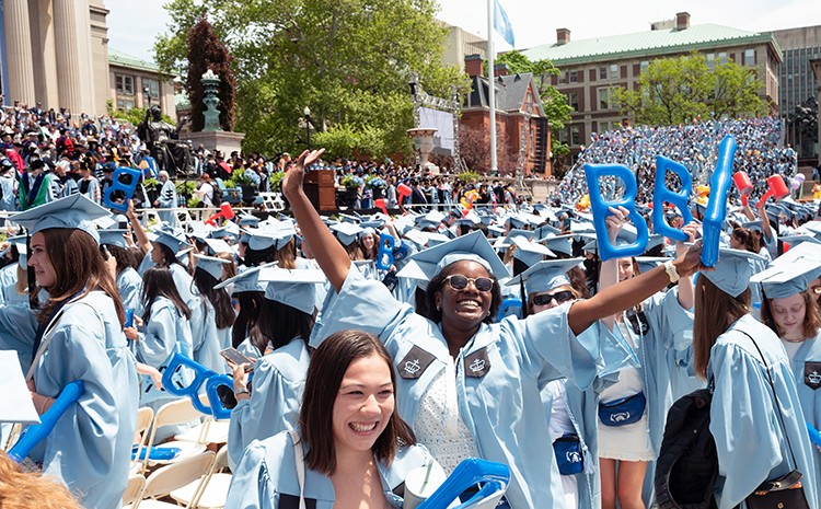 Joyful Barnard grads in caps and gowns at University Commencement. 
