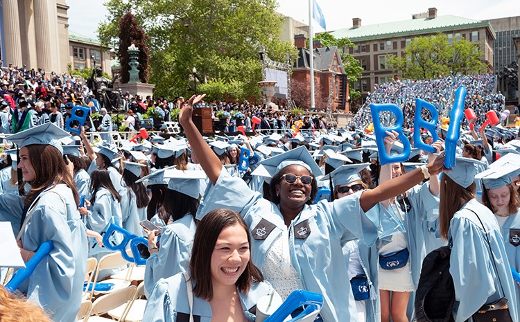 Joyful Barnard grads during University Commencement. Photo by Diane Bondareff. Joyful Barnard grads in caps and gowns at University Commencement.